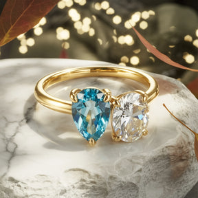 The Celestria Pear Cut Blue Moissanite & Oval Cut Moissanite Ring