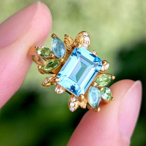 Blooming 1CT Emerald Cut Blue Gemstone Leafy Halo Engagement Ring